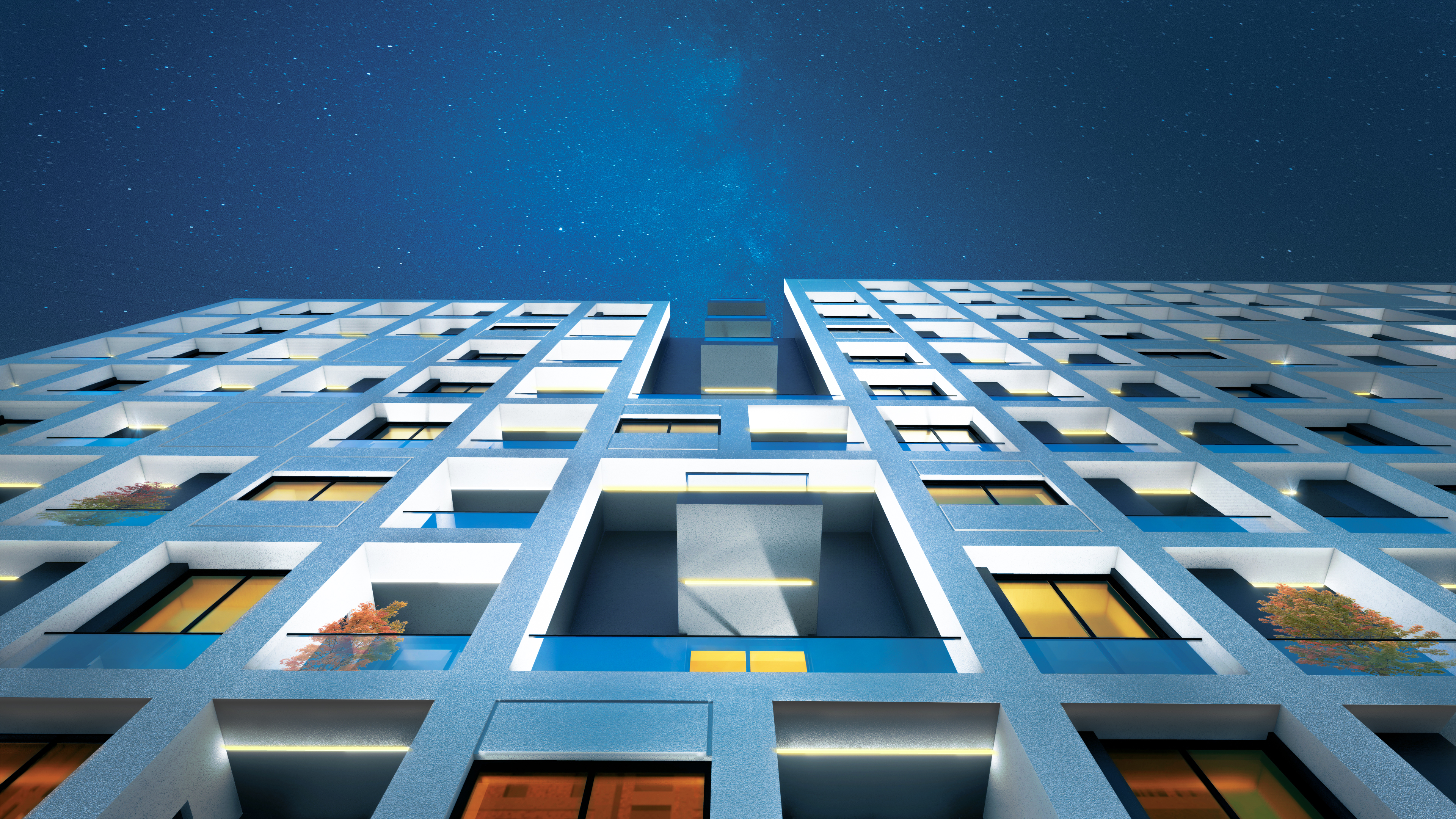 Koi Residence at night in Tirana, the white grid facade lit from within